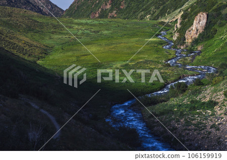 Mountain river in field in valley in Koksai gorge in the Aksu-Zhabagly Nature Reserve in Kazakhstan in summer Mountain river in field in valley in Koksai gorge in the Aksu-Zhabagly Nature Reserve in Kazakhstan in summer 106159919