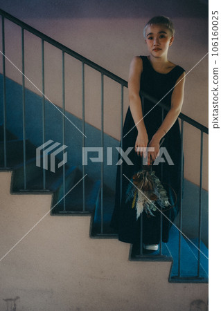 young woman standing on the stairs young woman standing on the stairs 106160025
