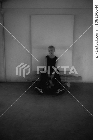 Black and white photo of a young woman standing indoors Black and white photo of a young woman standing indoors 106160044