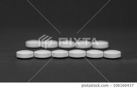 Pills neatly arranged, drugs on black background. Pills neatly arranged, drugs on black background. 106160437