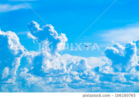 Cumulonimbus clouds rising in the summer sky and airplanes flying around a-2 High saturation contrast Cumulonimbus clouds rising in the summer sky and airplanes flying around a-2 High saturation contrast 106160765