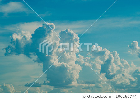 Cumulonimbus clouds rising in the summer sky and airplanes flying around b-5 film style Cumulonimbus clouds rising in the summer sky and airplanes flying around b-5 film style 106160774