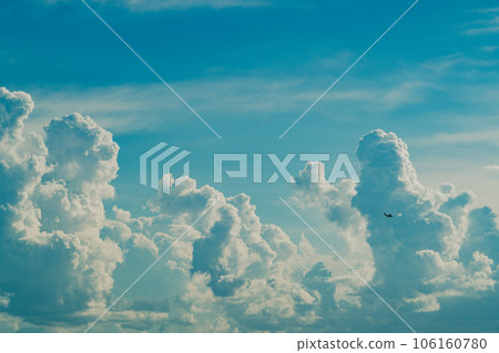 Cumulonimbus clouds rising in the summer sky and airplanes flying around c-5 film style Cumulonimbus clouds rising in the summer sky and airplanes flying around c-5 film style 106160780