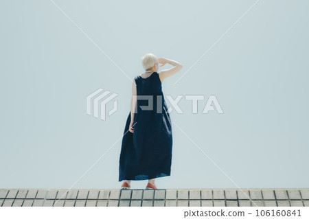 A woman standing in an empty background 106160841
