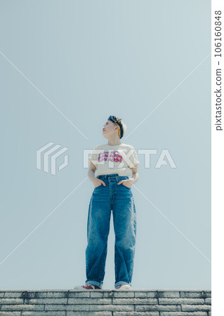 A woman standing in an empty background 106160848