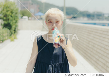 Woman walking with a plastic bottle 106160879