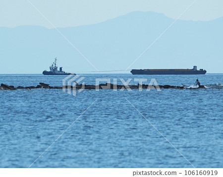 Tanker being towed by a tugboat 106160919