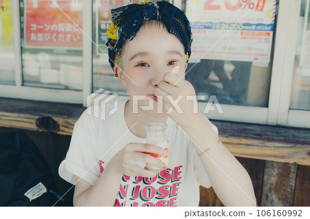 A woman eating pudding at a tourist spot 106160992