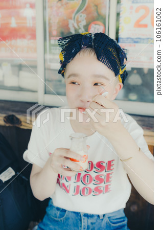 A woman eating pudding at a tourist spot A woman eating pudding at a tourist spot 106161002