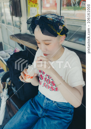 A woman eating pudding at a tourist spot 106161008