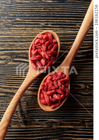 Dried goji berries in wooden spoons. Dried goji berries in wooden spoons. 106162156