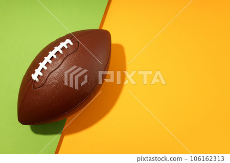 American football ball on two tone background 106162313