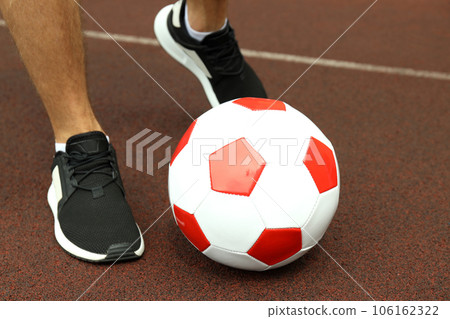 Male legs in sneakers and football ball Male legs in sneakers and football ball 106162322