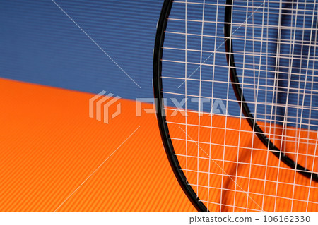 Badminton rackets on orange and blue textured backgrounds 106162330