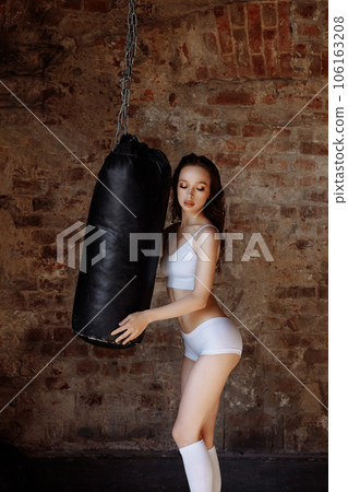 Sexy woman on the background of a punching bag 106163208
