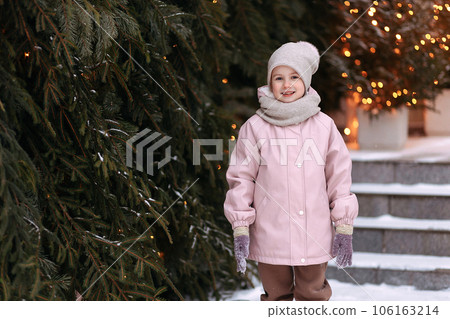 Portrait of a happy child holding a snowball 106163214