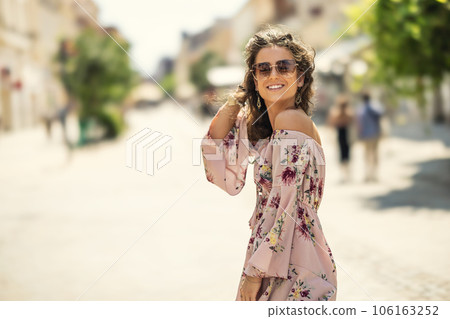 Happy young smiling woman in summer outfit with sunglasses. Outdoor portrait 106163252
