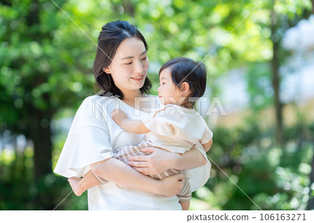 Young mother taking a walk with her baby in the park Young mother taking a walk with her baby in the park 106163271