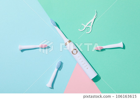 Electric toothbrushes on blue and green background, top view 106163615
