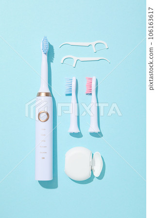 Electric toothbrushes on blue background, top view Electric toothbrushes on blue background, top view 106163617
