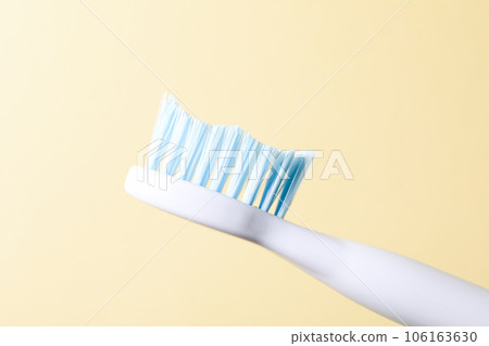 Blue electric toothbrush on beige background, close up Blue electric toothbrush on beige background, close up 106163630
