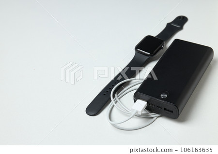 Powerbank, smart watch and cord on white background, space for text Powerbank, smart watch and cord on white background, space for text 106163635