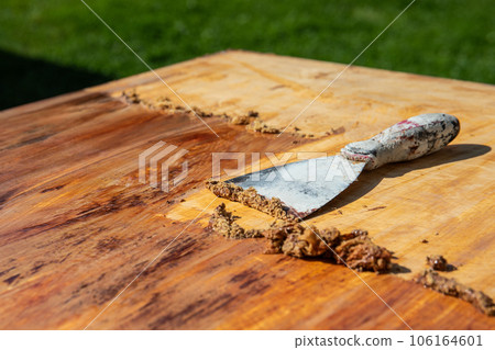 Removing the old paint with a trowel, renovation works Removing the old paint with a trowel, renovation works 106164601