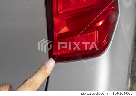 Male hand pointing at car brake light Male hand pointing at car brake light 106166063