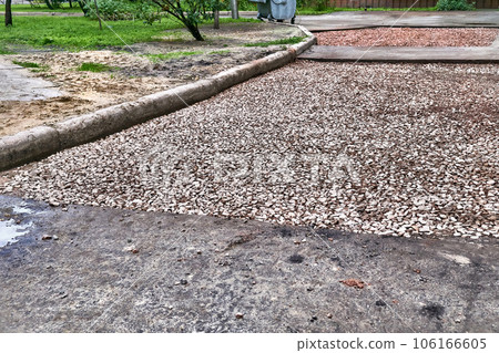 Road repair. Roadbed with laid gravel before asphalt laying 106166605