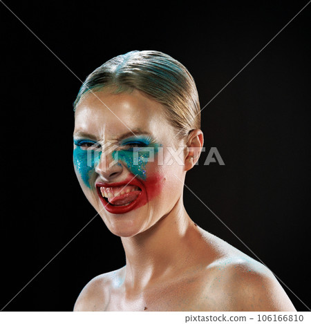 Young beautiful woman with smeared bright makeup under eyes and sparkles on cheeks and bare shoulders. Extraordinary, grimacing face. 106166810