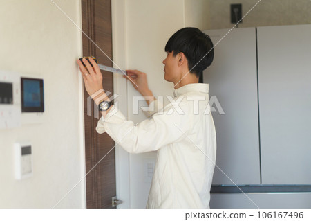 A man measuring the room A man measuring the room 106167496
