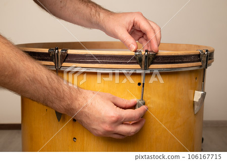 close-up of repairing and adjusting the tension of a kick bass drum 106167715