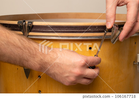 close-up of repairing and adjusting the tension of a kick bass drum 106167718