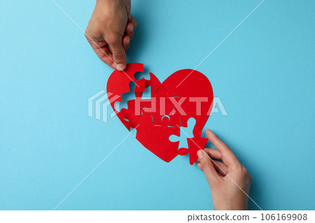 Red heart from puzzles on a blue background. Blood donation Red heart from puzzles on a blue background. Blood donation 106169908