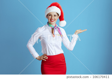 smiling elegant stewardess woman on blue presenting something smiling elegant stewardess woman on blue presenting something 106170411