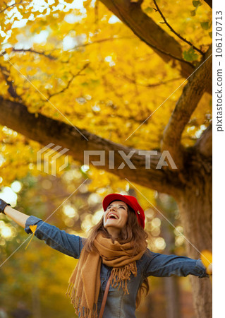 happy young woman in jeans shirt and red hat rejoicing happy young woman in jeans shirt and red hat rejoicing 106170713