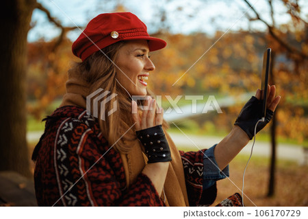 female using phone and having call in city park 106170729