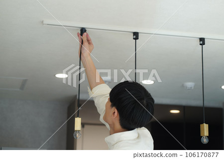 Men installing lighting equipment Men installing lighting equipment 106170877