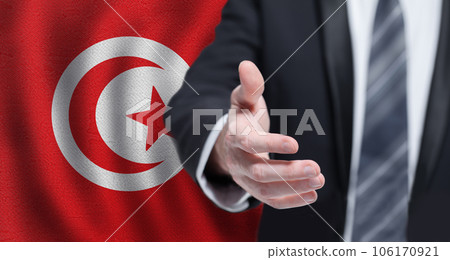 Tunisian business, politics, cooperation and travel concept. Hand on flag of Tunisia background. Tunisian business, politics, cooperation and travel concept. Hand on flag of Tunisia background. 106170921