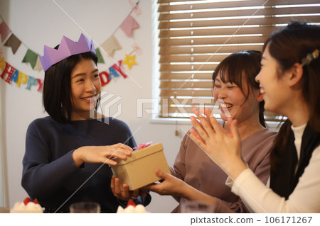 A woman receiving a present A woman receiving a present 106171267