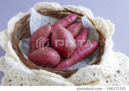 Various kinds of sweet potatoes in a round basket Warm image 106172105