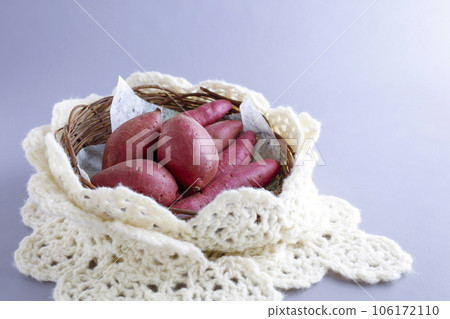 Various kinds of sweet potatoes in a round basket Warm image 106172110