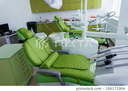 Modern dental office in green. Dental unit with dental instruments. Autoclave Modern dental office in green. Dental unit with dental instruments. Autoclave 106172904