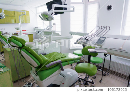 Modern dental office in green. Dental unit with dental instruments. Autoclave Modern dental office in green. Dental unit with dental instruments. Autoclave 106172923