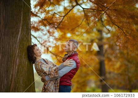 smiling romantic family in park hugging near tree 106172933
