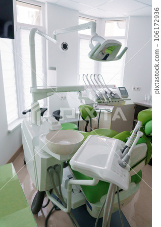 Modern dental office in green. Dental unit with dental instruments. Autoclave 106172936