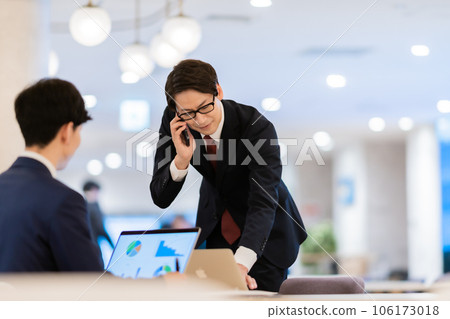 一個穿著西裝的商人在用智能手機說話 106173018