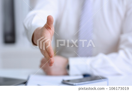 Man in suit and tie give hand as hello 106173019