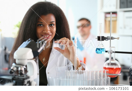 A male chemist holds test tube of glass A male chemist holds test tube of glass 106173101