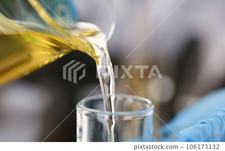 Male hands in protective gloves hold test tube 106173132